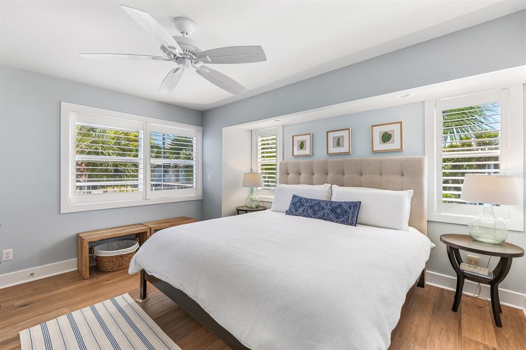 5000 Gasparilla Road, Unit 19 Boca Grande, FL 33921 - Photo 11 of 48 a bedroom with a large bed and a table