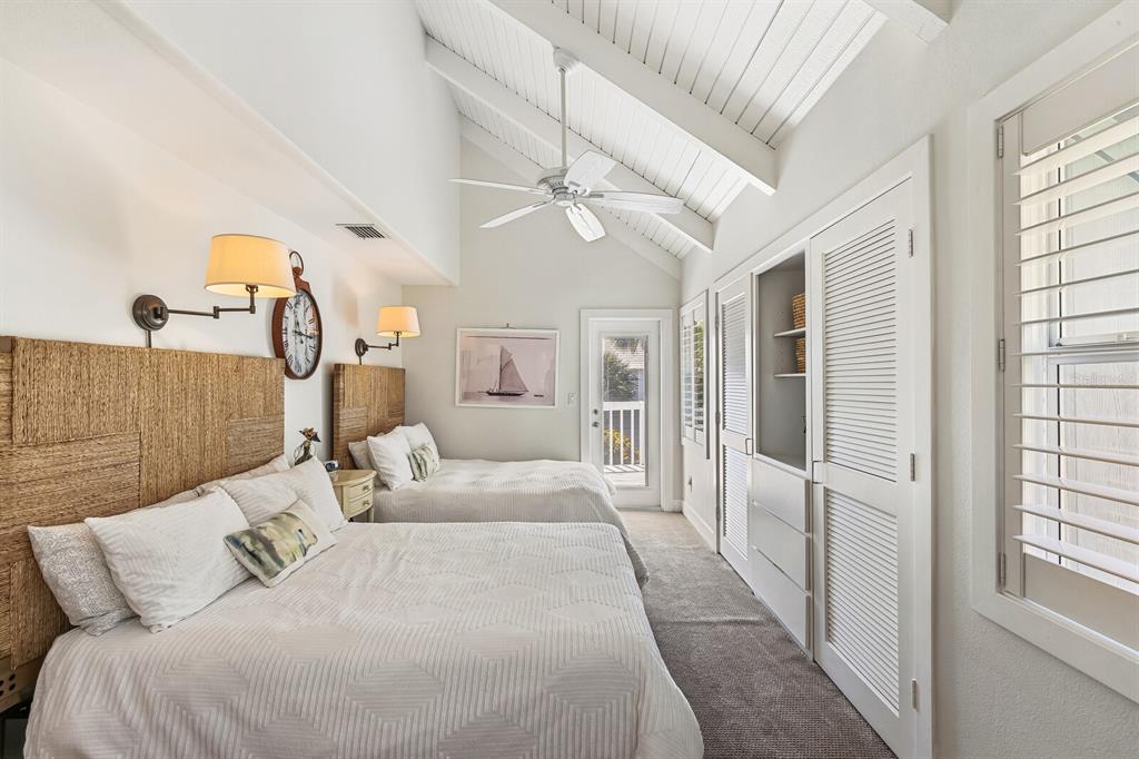 5000 Gasparilla Road, Unit 19 Boca Grande, FL 33921 - Photo 12 of 48 a bedroom with a large bed and a chandelier