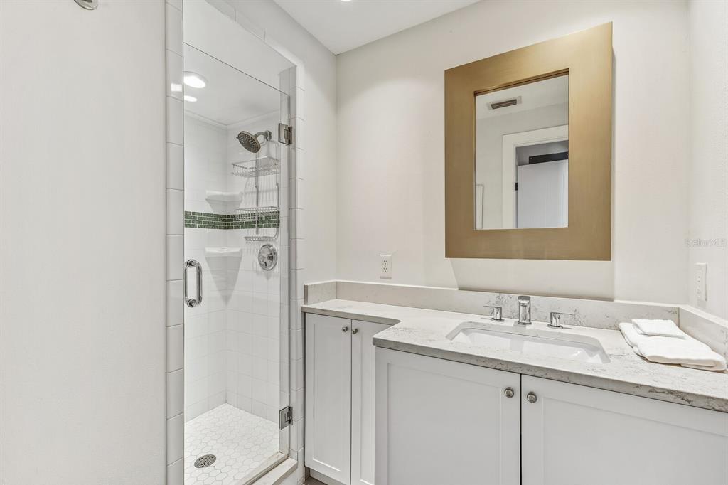 5000 Gasparilla Road, Unit 19 Boca Grande, FL 33921 - Photo 14 of 48 a bathroom with a granite countertop sink toilet and shower