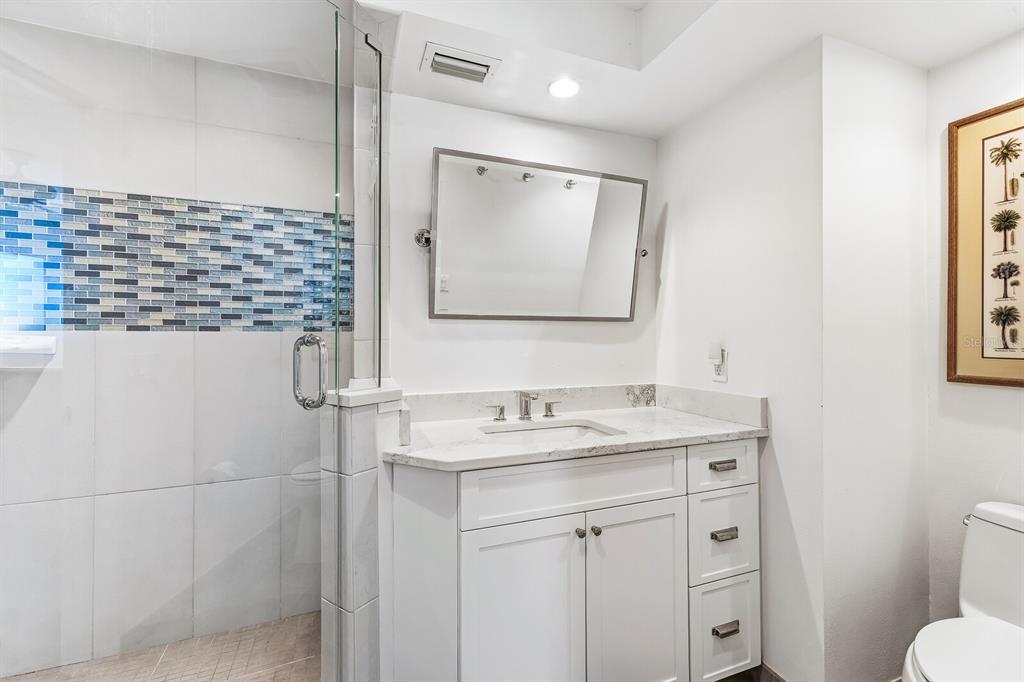 5000 Gasparilla Road, Unit 19 Boca Grande, FL 33921 - Photo 15 of 48 a bathroom with a sink a toilet and a mirror