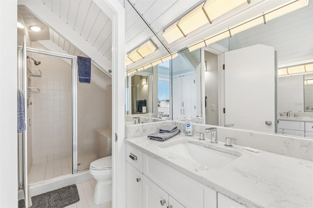 5000 Gasparilla Road, Unit 19 Boca Grande, FL 33921 - Photo 16 of 48 a bathroom with a sink a toilet and shower