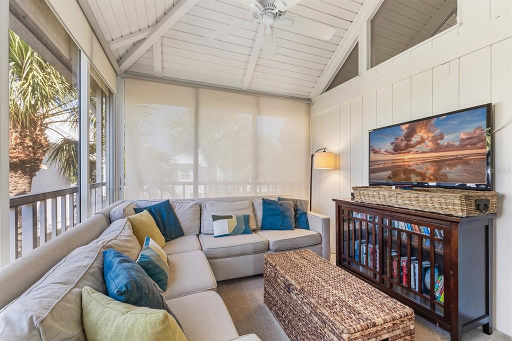 5000 Gasparilla Road, Unit 19 Boca Grande, FL 33921 - Photo 18 of 48 a living room with furniture and a flat screen tv