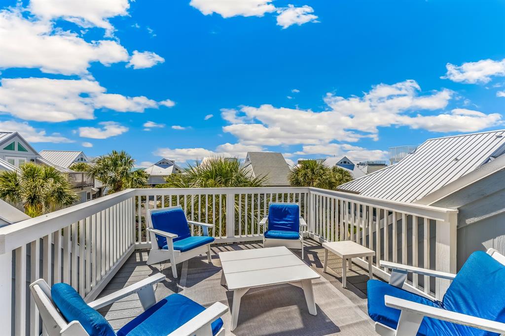 5000 Gasparilla Road, Unit 19 Boca Grande, FL 33921 - Photo 19 of 48 a view of a balcony with chair and wooden floor