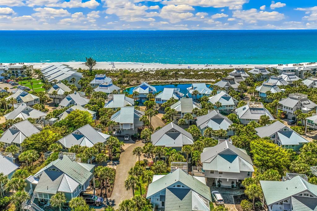 5000 Gasparilla Road, Unit 19 Boca Grande, FL 33921 - Photo 22 of 48 an aerial view of a building with an outdoor space and seating