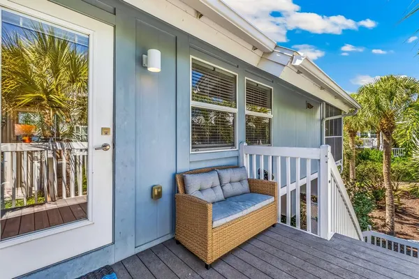 a view of a balcony with furniture and wooden floor