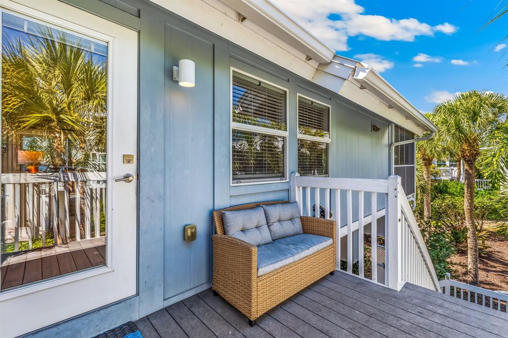 5000 Gasparilla Road, Unit 19 Boca Grande, FL 33921 - Photo 3 of 48 a view of a balcony with furniture and wooden floor