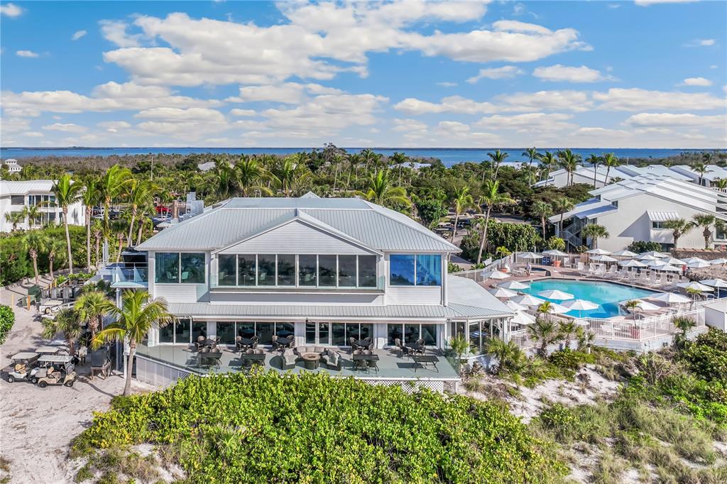 5000 Gasparilla Road, Unit 19 Boca Grande, FL 33921 - Photo 45 of 48 an aerial view of a house with a garden and lake view