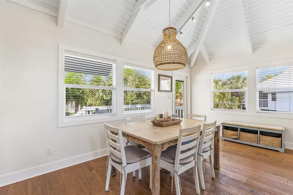 a view of a dining room with furniture wooden floor and chandelier