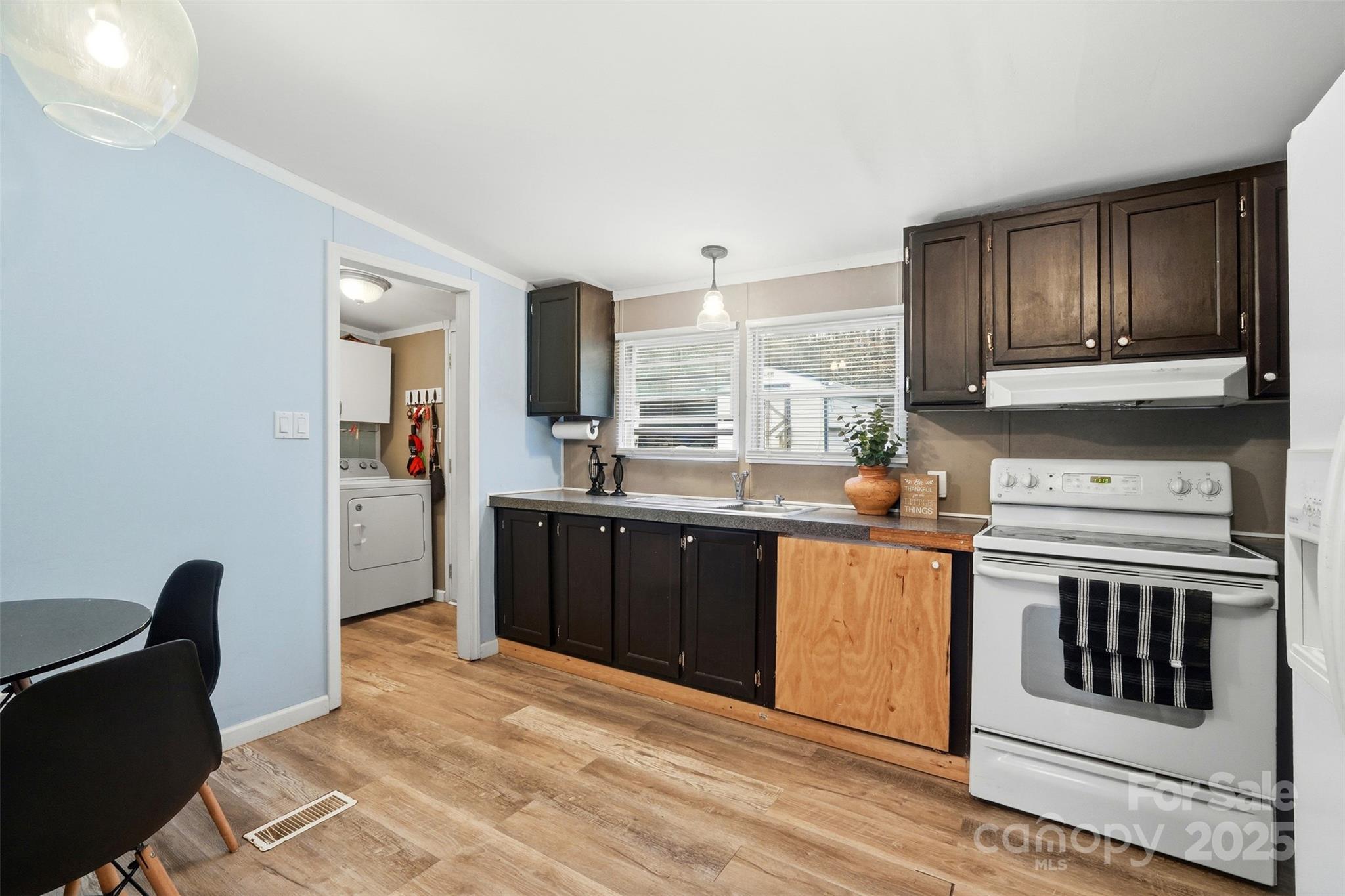 2338 Whelchel Road Mooresboro, NC 28114 - Photo 3 of 20 a kitchen with stainless steel appliances granite countertop a stove a sink and a refrigerator