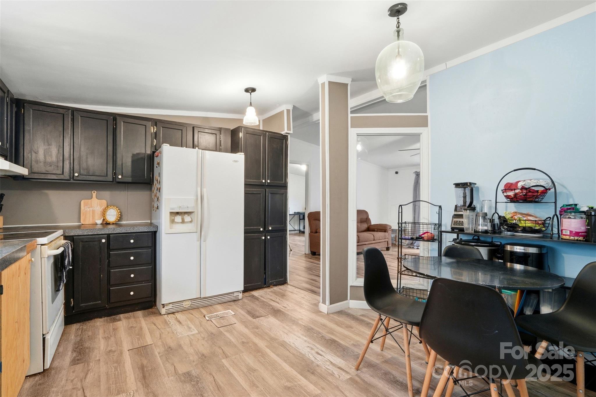 2338 Whelchel Road Mooresboro, NC 28114 - Photo 4 of 20 a kitchen with stainless steel appliances granite countertop a refrigerator a stove a sink dishwasher a dining table and chairs with wooden floor