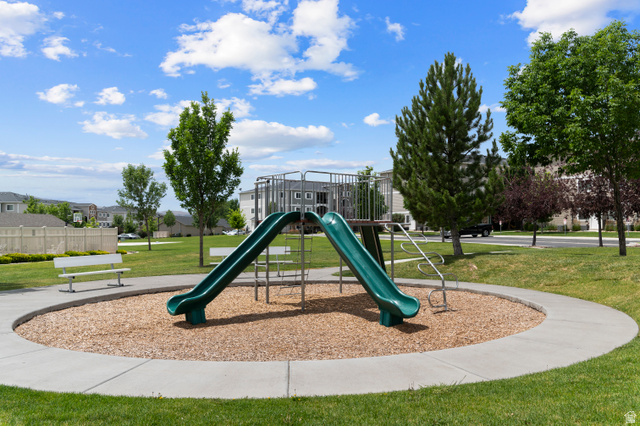 25 West Ridge Road, Unit 25 Saratoga Springs, UT 84045 - Photo 21 of 22 Community playground featuring two green slides and a climbing structure