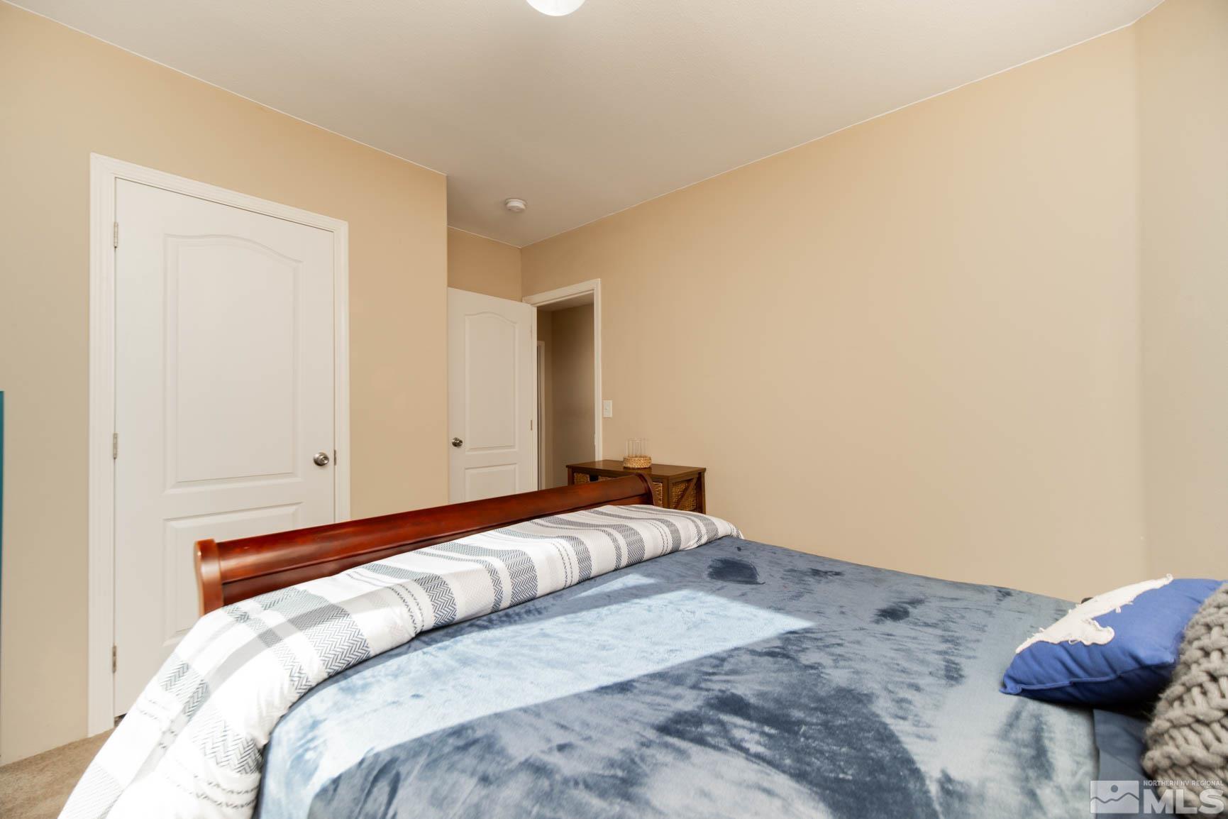 16210 Rhyolite Circle Reno, NV 89521 - Photo 20 of 39 a bedroom with a bed and pillows