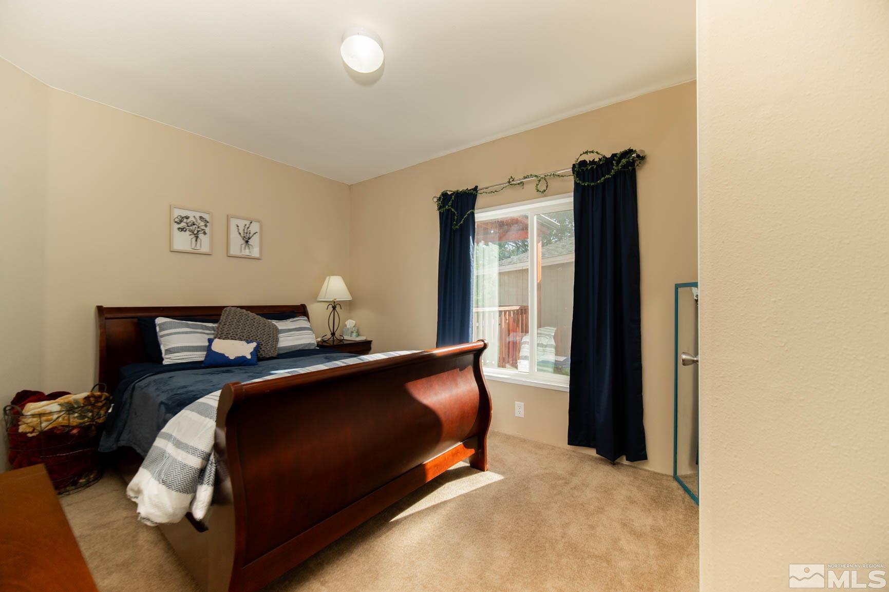 16210 Rhyolite Circle Reno, NV 89521 - Photo 21 of 39 a bed room with a bed and a window