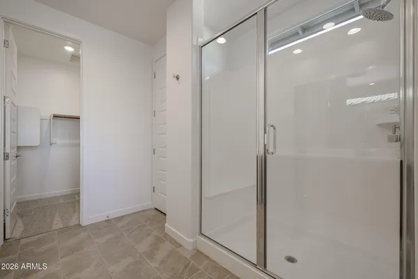 a bathroom with a glass shower door