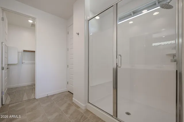 a bathroom with a glass shower door