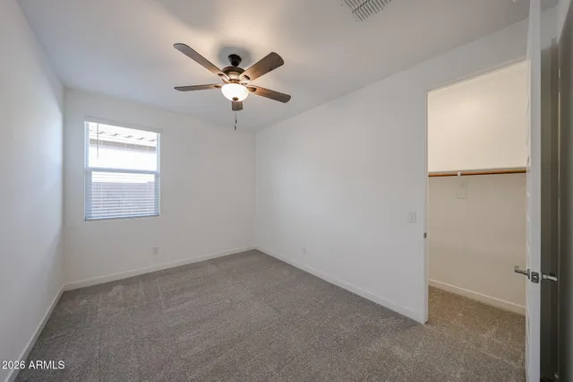 a view of a room with a fan & a window