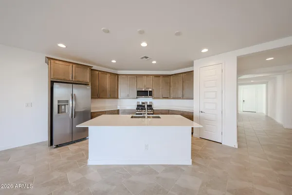 a view of kitchen with refrigerator stove microwave and cabinets