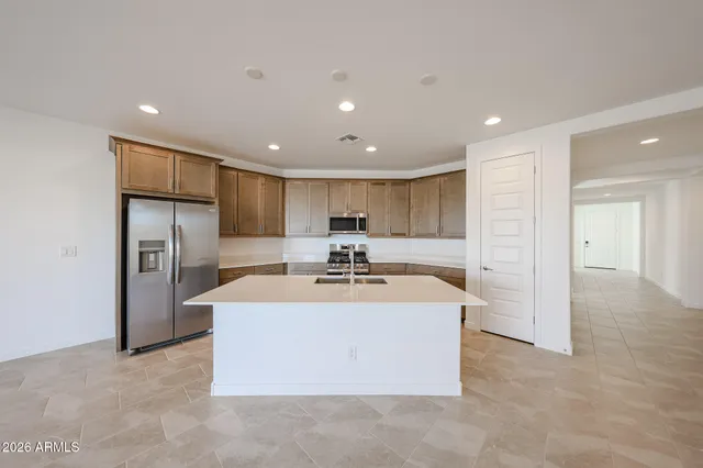 a view of kitchen with refrigerator stove microwave and cabinets
