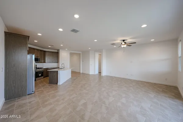 a view of kitchen with refrigerator and ceiling fan