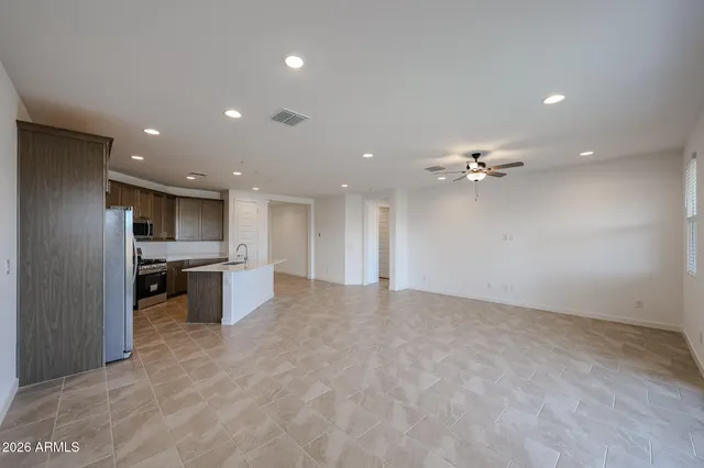 a view of kitchen with refrigerator and ceiling fan