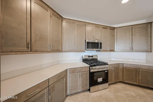 a kitchen with a sink stove and microwave