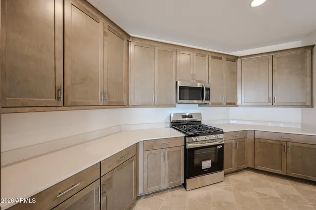 a kitchen with a sink stove and microwave
