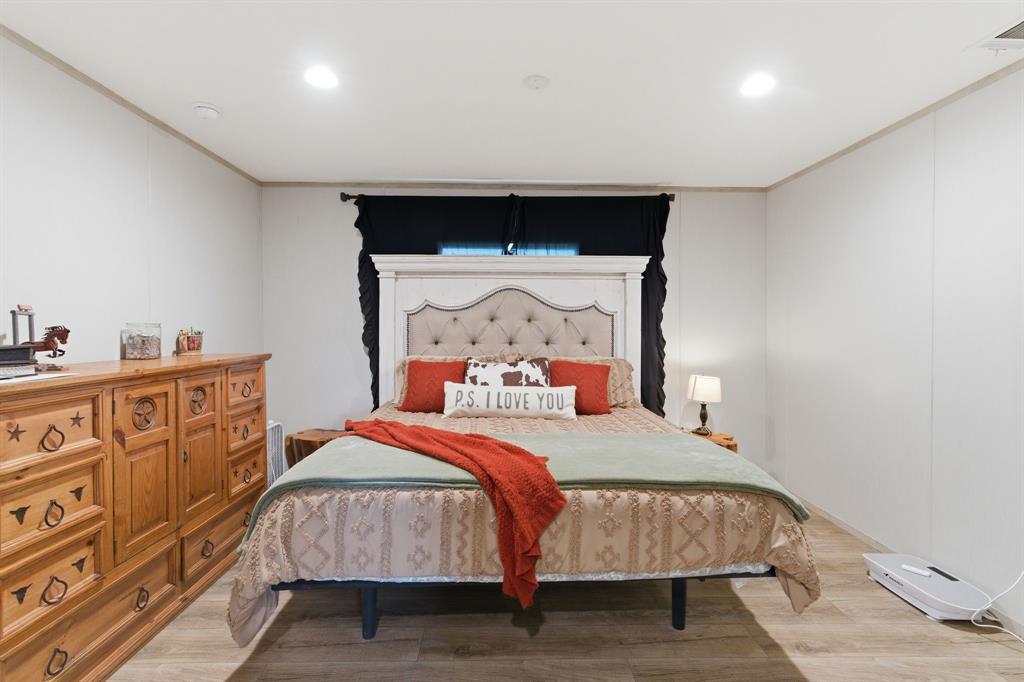 8792 Highway 67 Saltillo, TX 75478 - Photo 18 of 40 a bedroom with a bed and wooden floor