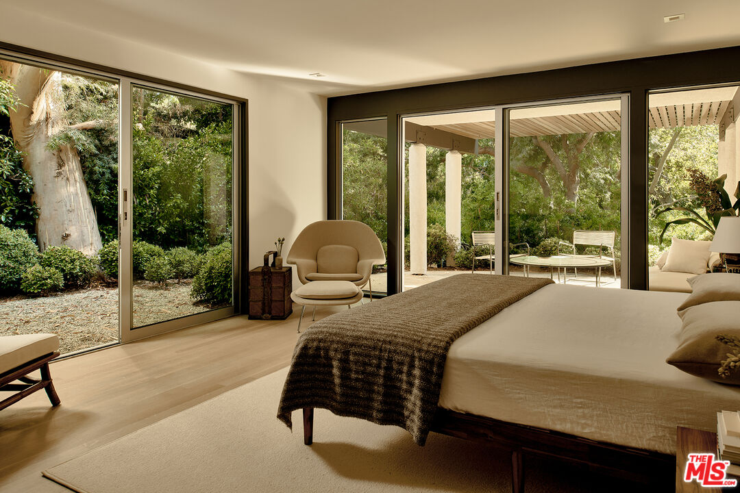 790 Burleigh Drive Pasadena, CA 91105 - Photo 24 of 47 a bedroom with a bed lamp and large windows