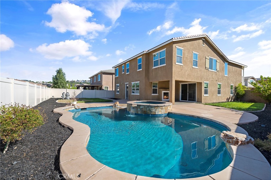 a swimming pool with outdoor seating yard and barbeque oven