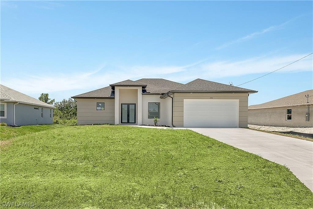 2921 7th Street Southwest Lehigh Acres, FL 33976 - Photo 1 of 8 a house view with a garden space