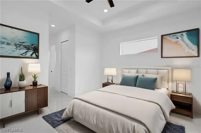 a bedroom with a bed a couch and potted plant