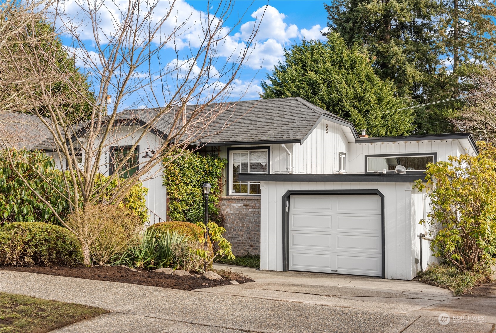 8850 30th Avenue Southwest Seattle, WA 98126 - Photo 1 of 39 a house with a tree in the background