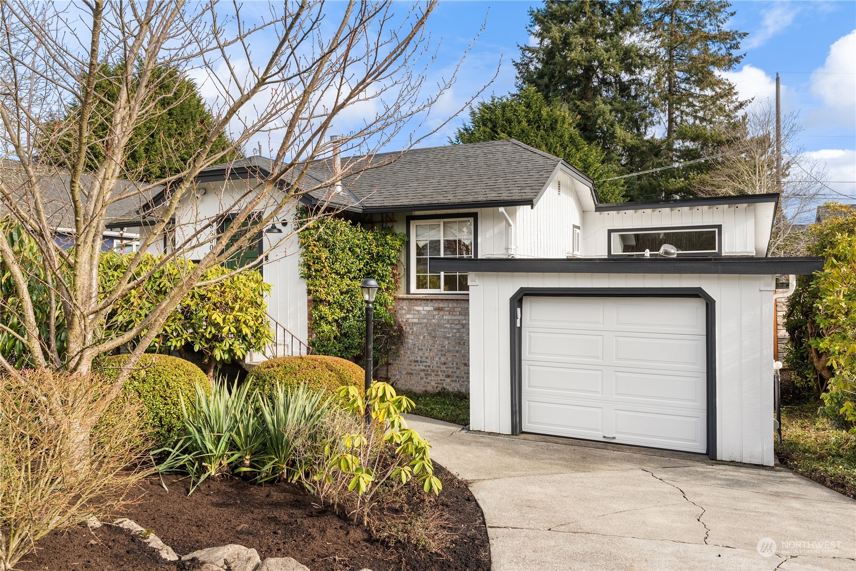 8850 30th Avenue Southwest Seattle, WA 98126 - Photo 39 of 39 a front view of a house with a garden