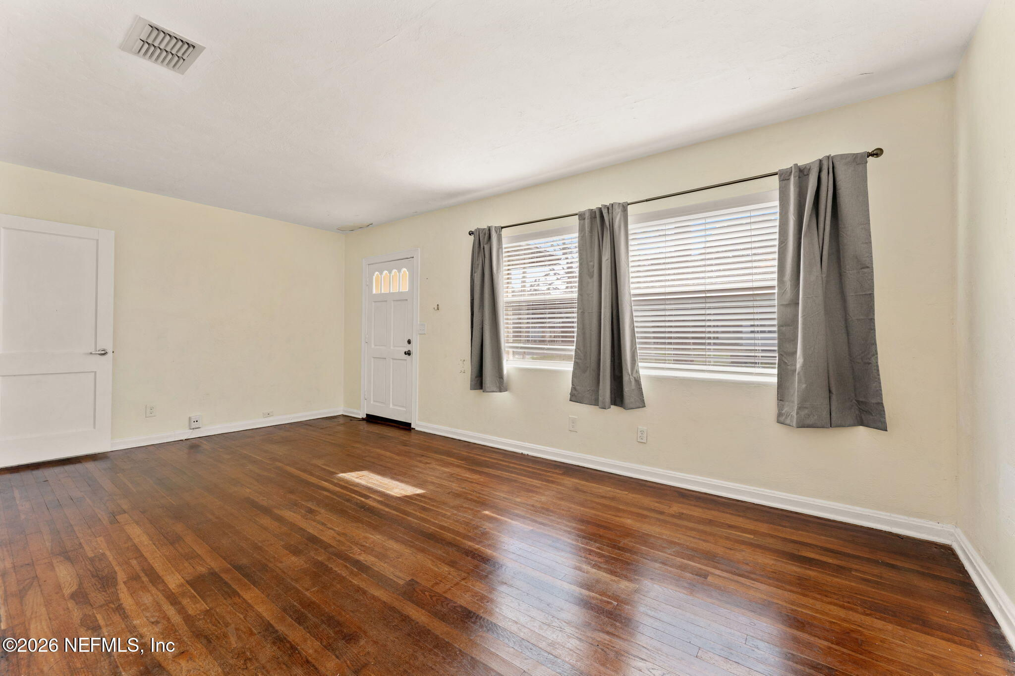 5331 Sharon Terrace Jacksonville, FL 32207 - Photo 4 of 16 an empty room with wooden floor and windows