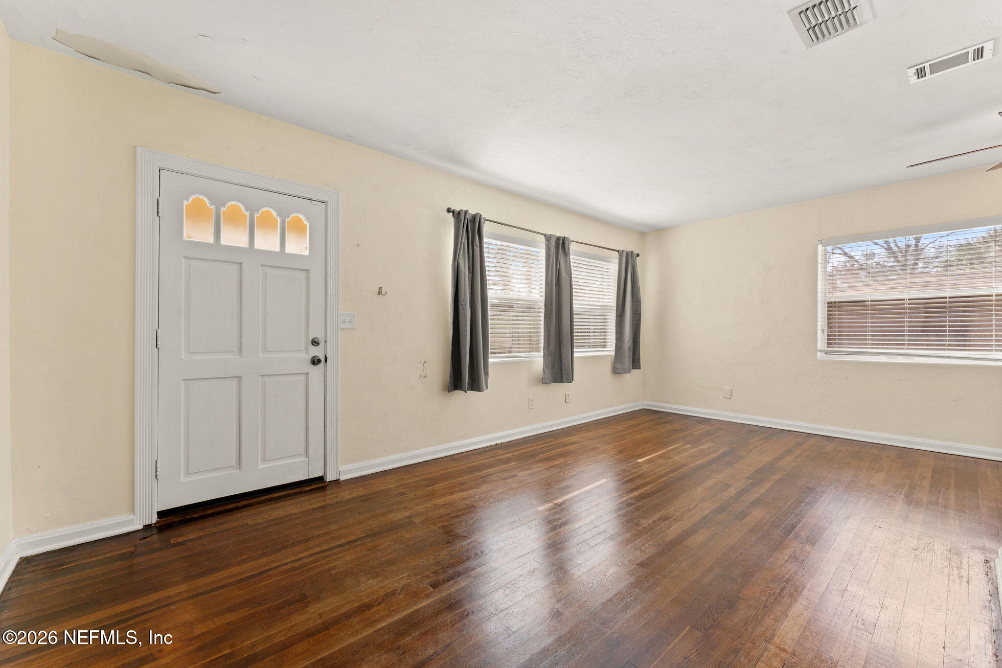 5331 Sharon Terrace Jacksonville, FL 32207 - Photo 5 of 16 a view of an empty room with wooden floor and windows
