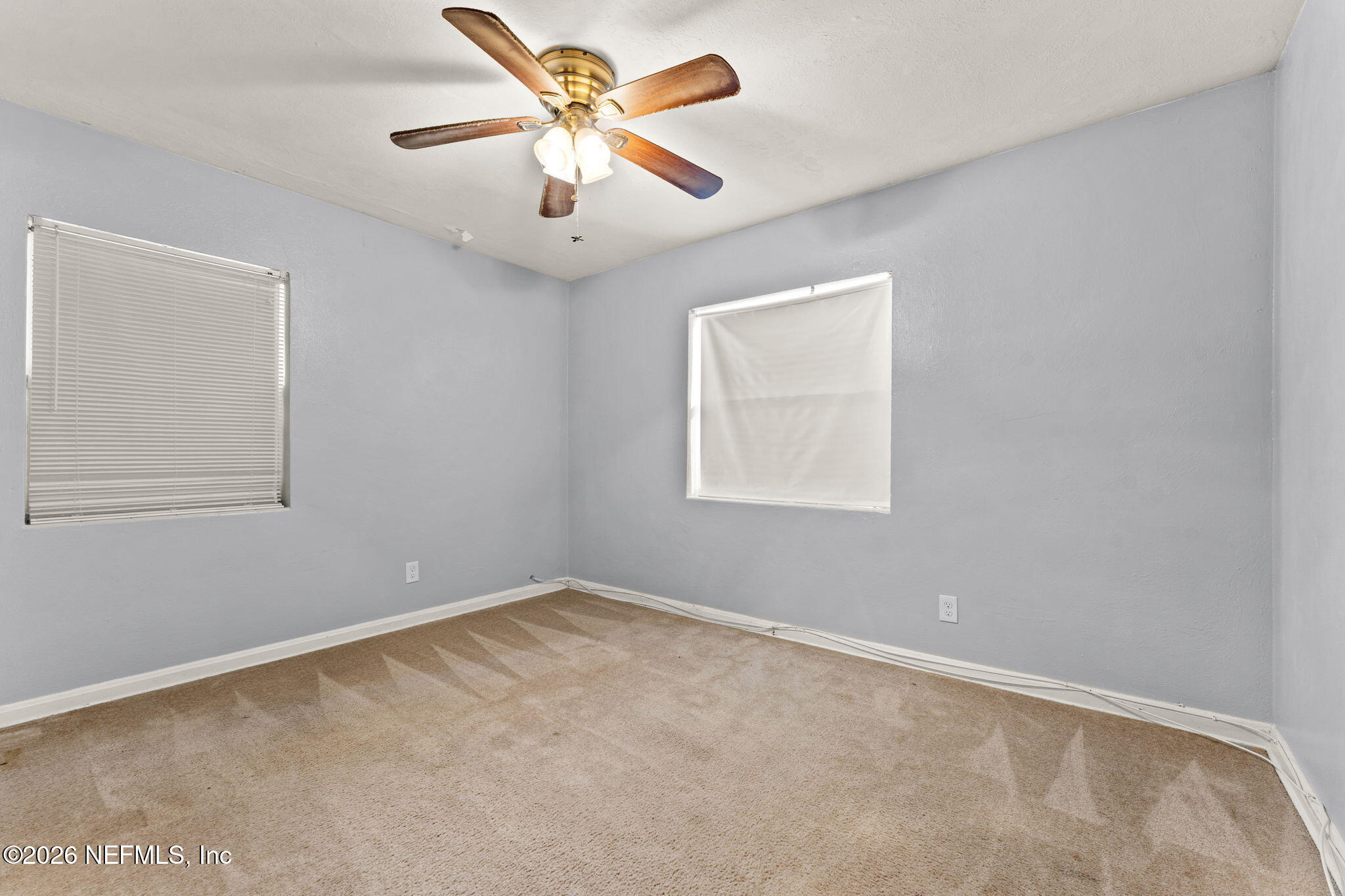 5331 Sharon Terrace Jacksonville, FL 32207 - Photo 10 of 16 an empty room with a window and a fan