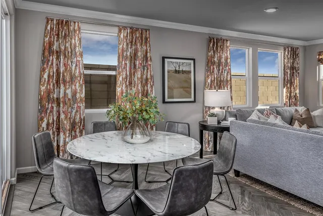a dining room with furniture and window