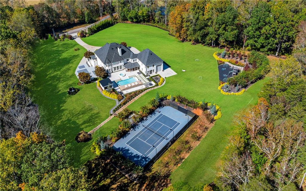 7160 Bennett Road Cumming, GA 30041 - Photo 1 of 83 an aerial view of a house with a garden and trees