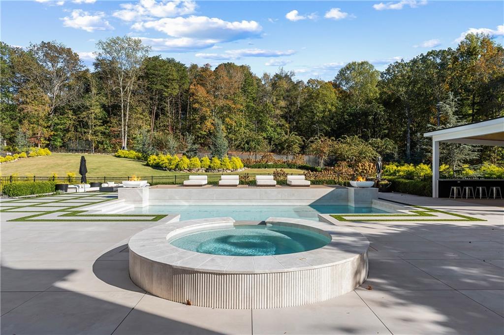 7160 Bennett Road Cumming, GA 30041 - Photo 20 of 83 a view of a swimming pool with outdoor seating