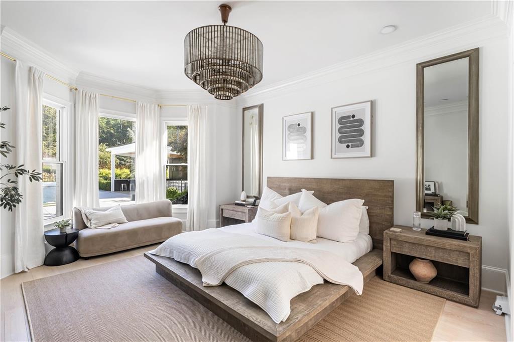7160 Bennett Road Cumming, GA 30041 - Photo 32 of 83 a spacious bedroom with a bed a couch and a chandelier