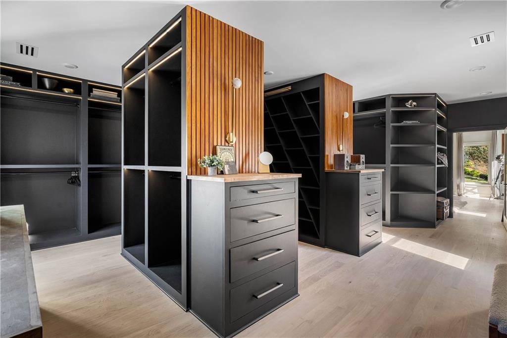 7160 Bennett Road Cumming, GA 30041 - Photo 39 of 83 a view of walk in closet with clothes and shoes