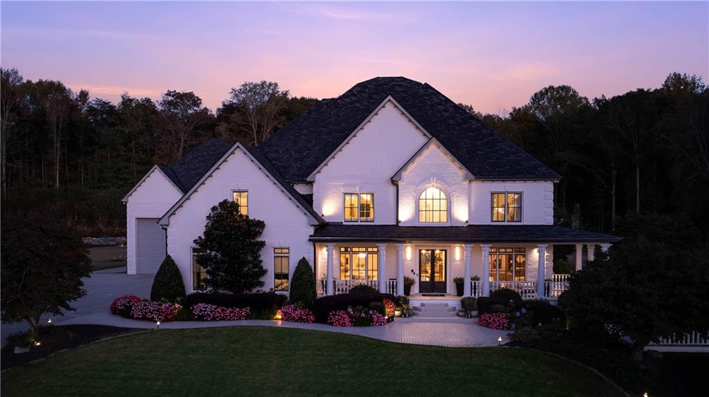7160 Bennett Road Cumming, GA 30041 - Photo 4 of 83 a view of a white house with large windows and a yard in front of it