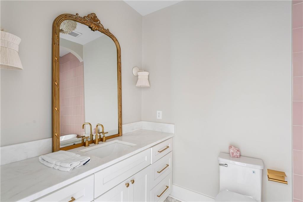 7160 Bennett Road Cumming, GA 30041 - Photo 45 of 83 a bathroom with a sink and a mirror