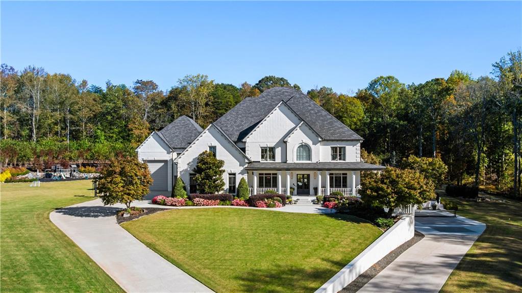 7160 Bennett Road Cumming, GA 30041 - Photo 80 of 83 a front view of a house with garden and trees
