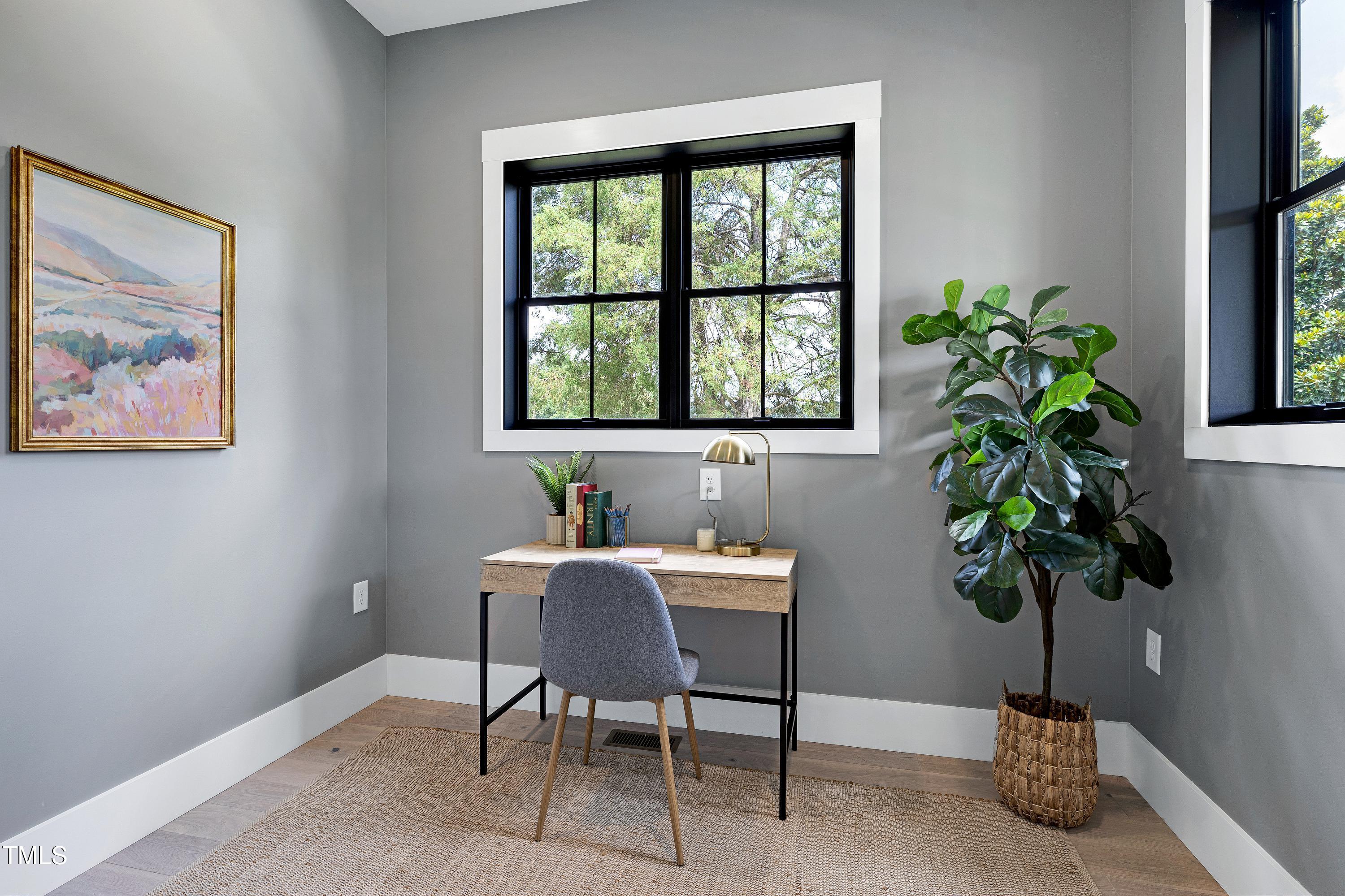 6509 Zebulon Road Wake Forest, NC 27587 - Photo 19 of 100 a view of a workspace with a potted plant and a window