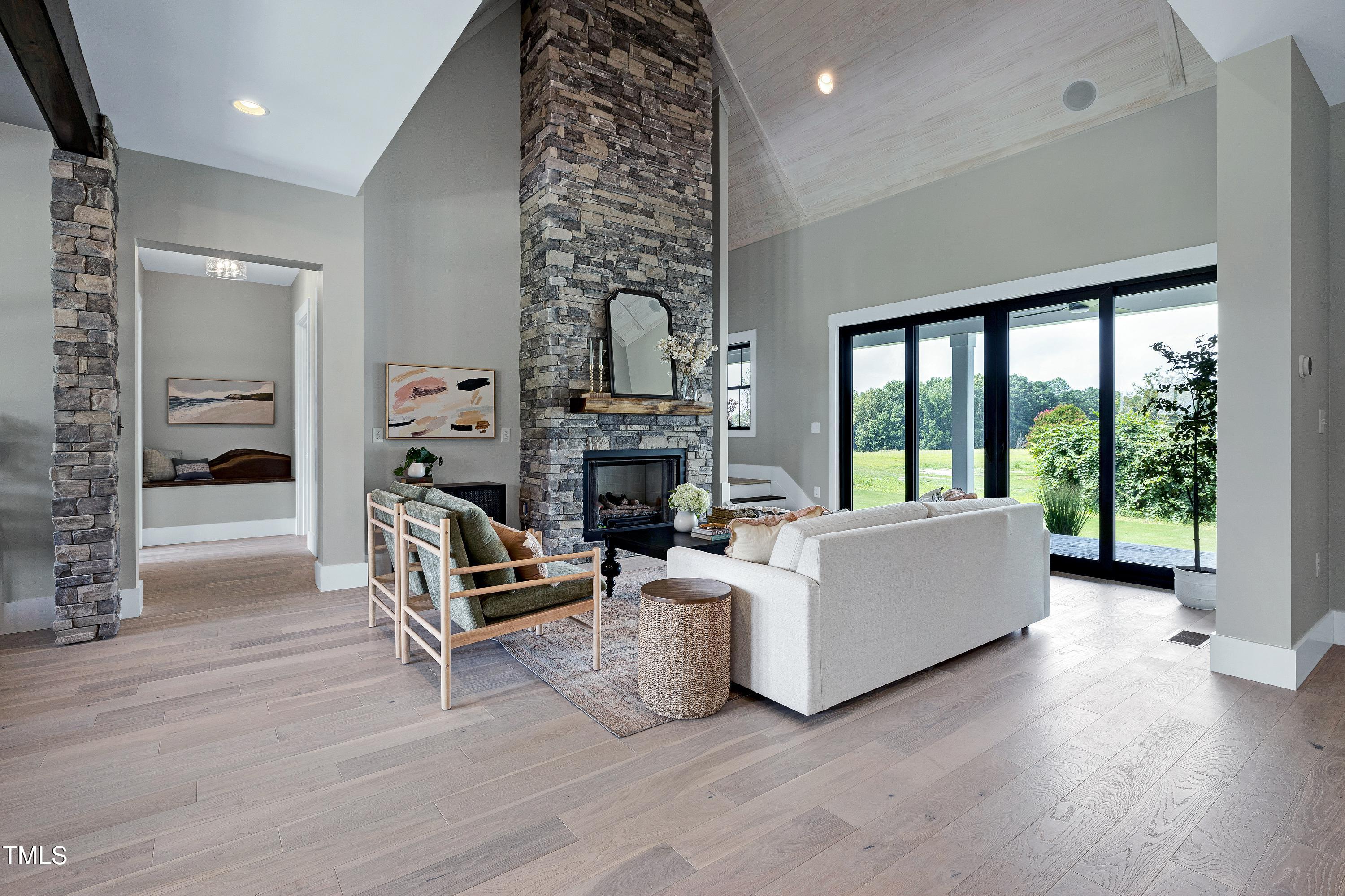 6509 Zebulon Road Wake Forest, NC 27587 - Photo 21 of 100 a living room with furniture large window and a fireplace