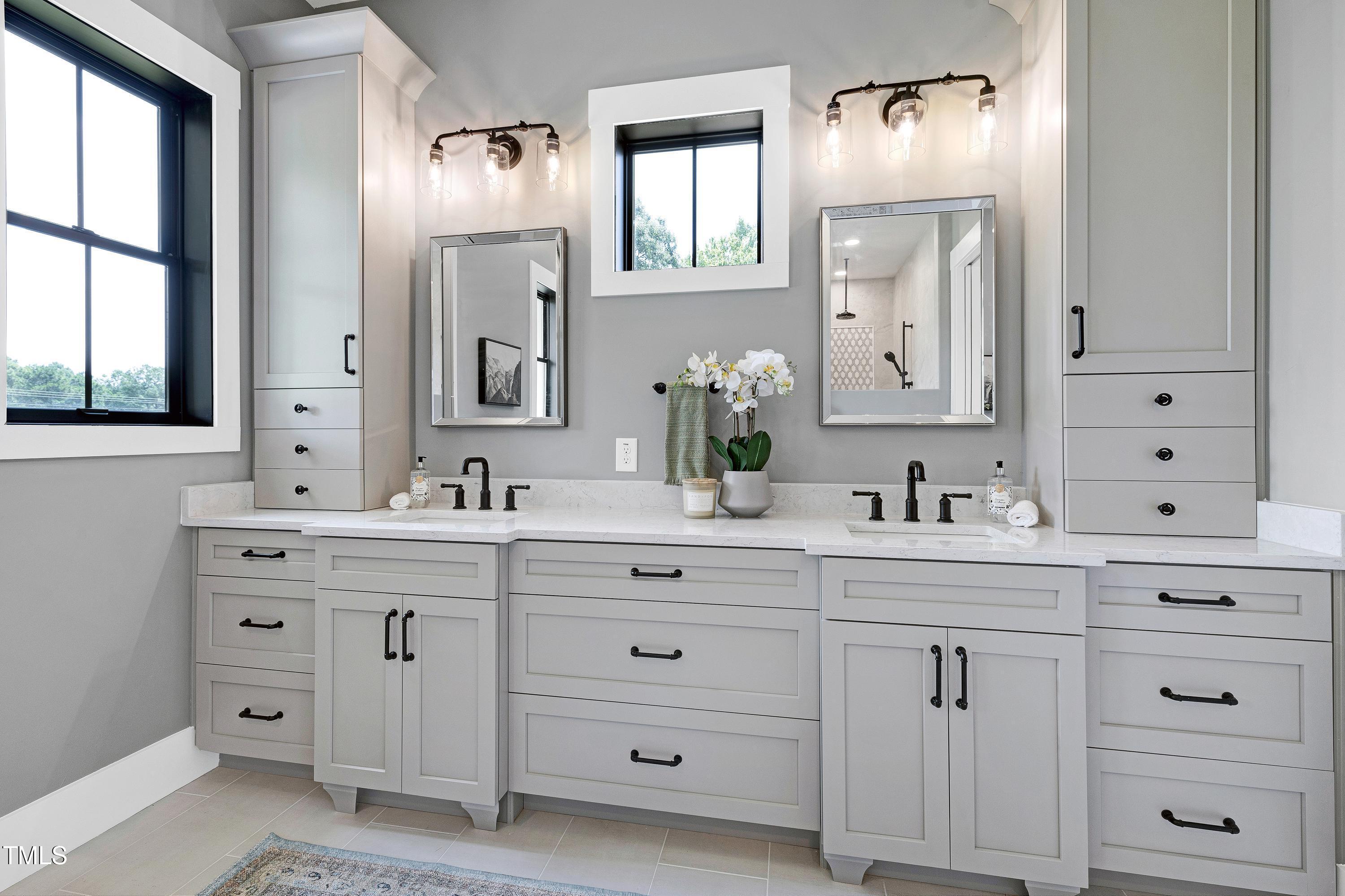 6509 Zebulon Road Wake Forest, NC 27587 - Photo 29 of 100 a bathroom with double vanity sink a mirror and a window