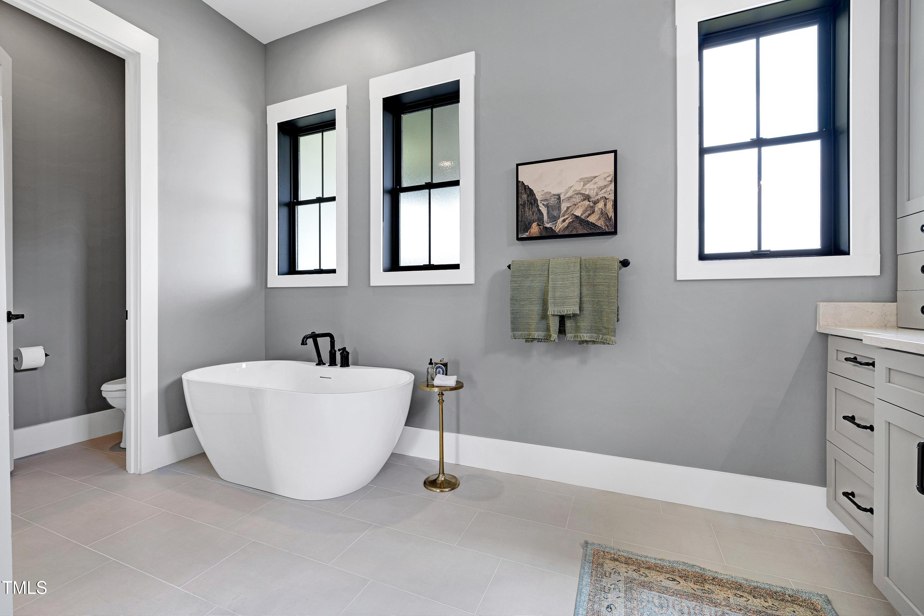 6509 Zebulon Road Wake Forest, NC 27587 - Photo 31 of 100 a bathroom with a bathtub and window