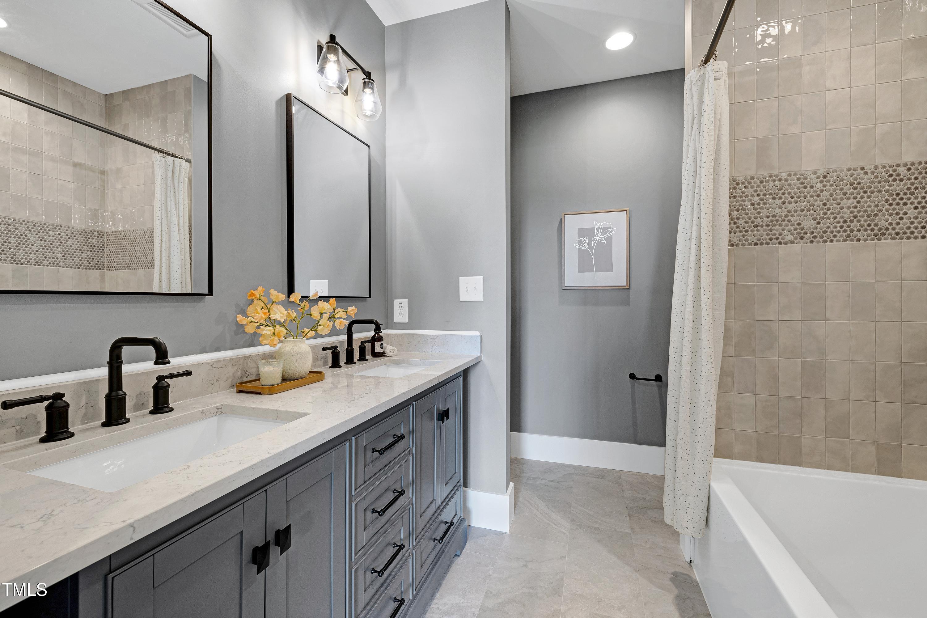 6509 Zebulon Road Wake Forest, NC 27587 - Photo 39 of 100 a bathroom with a double vanity sink mirror double and bathtub