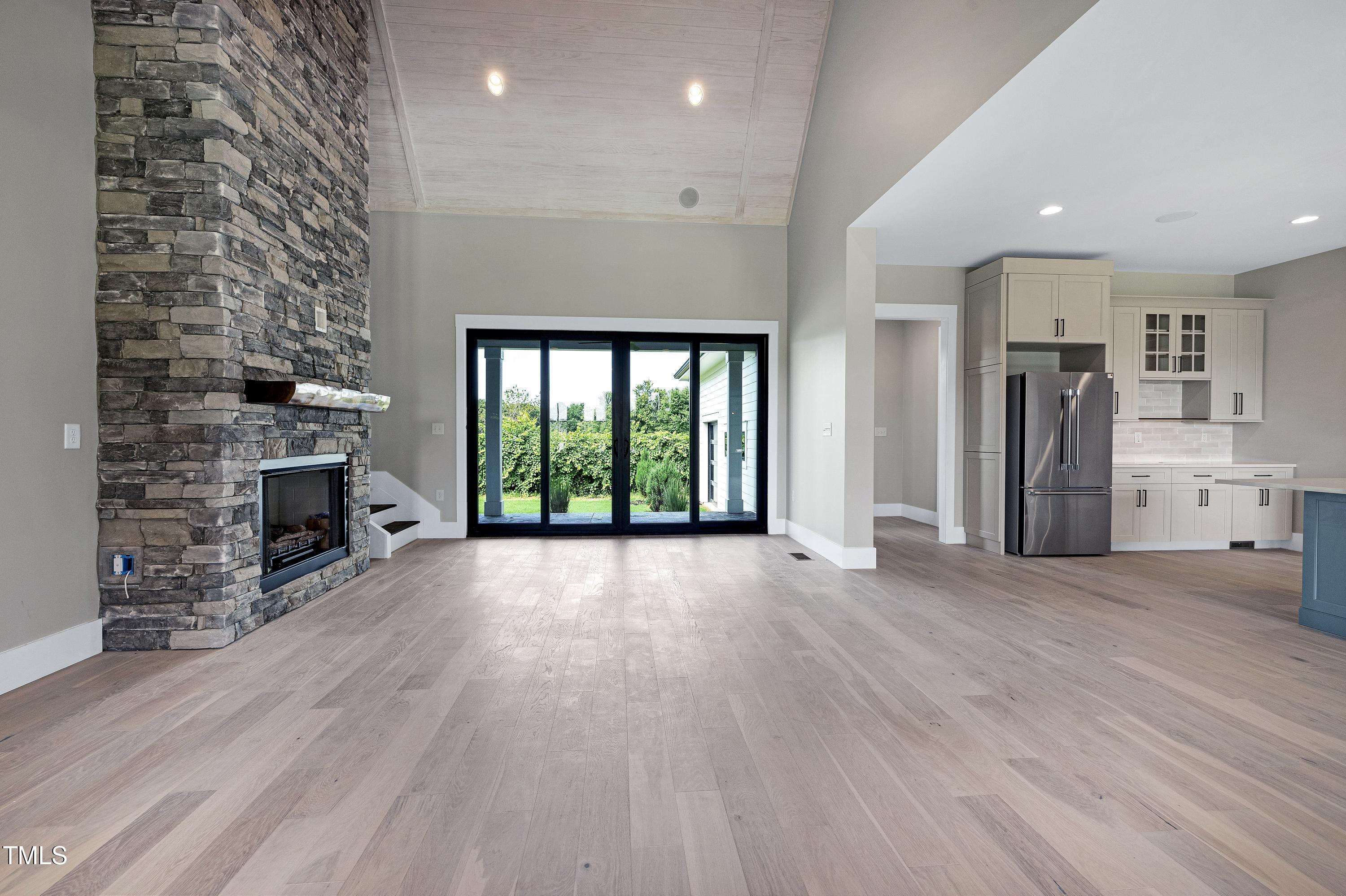6509 Zebulon Road Wake Forest, NC 27587 - Photo 45 of 100 an empty room with fireplace wooden floor and windows